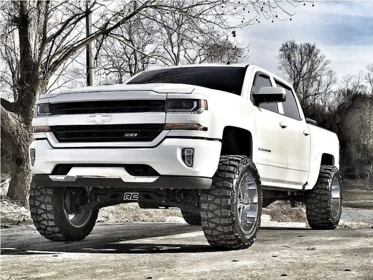 White lifted Chevrolet Silverado parked outdoors in East Tennessee.